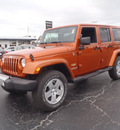 jeep wrangler unlimited 2011 orange suv sahara gasoline 6 cylinders 4 wheel drive automatic 28557
