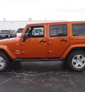 jeep wrangler unlimited 2011 orange suv sahara gasoline 6 cylinders 4 wheel drive automatic 28557
