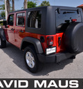 jeep wrangler unlimited 2010 red suv sport gasoline 6 cylinders 4 wheel drive 6 speed manual 32771