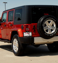 jeep wrangler unlimited 2009 orange suv sahara gasoline 6 cylinders 4 wheel drive automatic 62034
