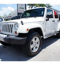 jeep wrangler unlimited 2010 white suv sahara gasoline 6 cylinders 4 wheel drive automatic 33157