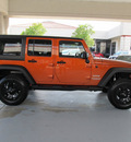 jeep wrangler unlimited 2011 orange suv sport gasoline 6 cylinders 4 wheel drive automatic with overdrive 77477