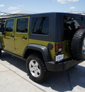 jeep wrangler unlimited 2010 green suv rubicon gasoline 6 cylinders 4 wheel drive 6 speed manual 76087