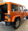 jeep wrangler unlimited 2012 orange suv sahara gasoline 6 cylinders 4 wheel drive automatic 60915