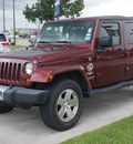 jeep wrangler unlimited 2009 red suv sahara gasoline 6 cylinders 4 wheel drive automatic 77090